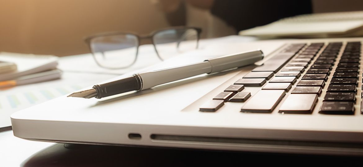 business-concept-with-copy-space-office-desk-table-with-pen-focus-analysis-chart-computer-notebook-cup-coffee-desk-vintage-tone-retro-filter-selective-focus